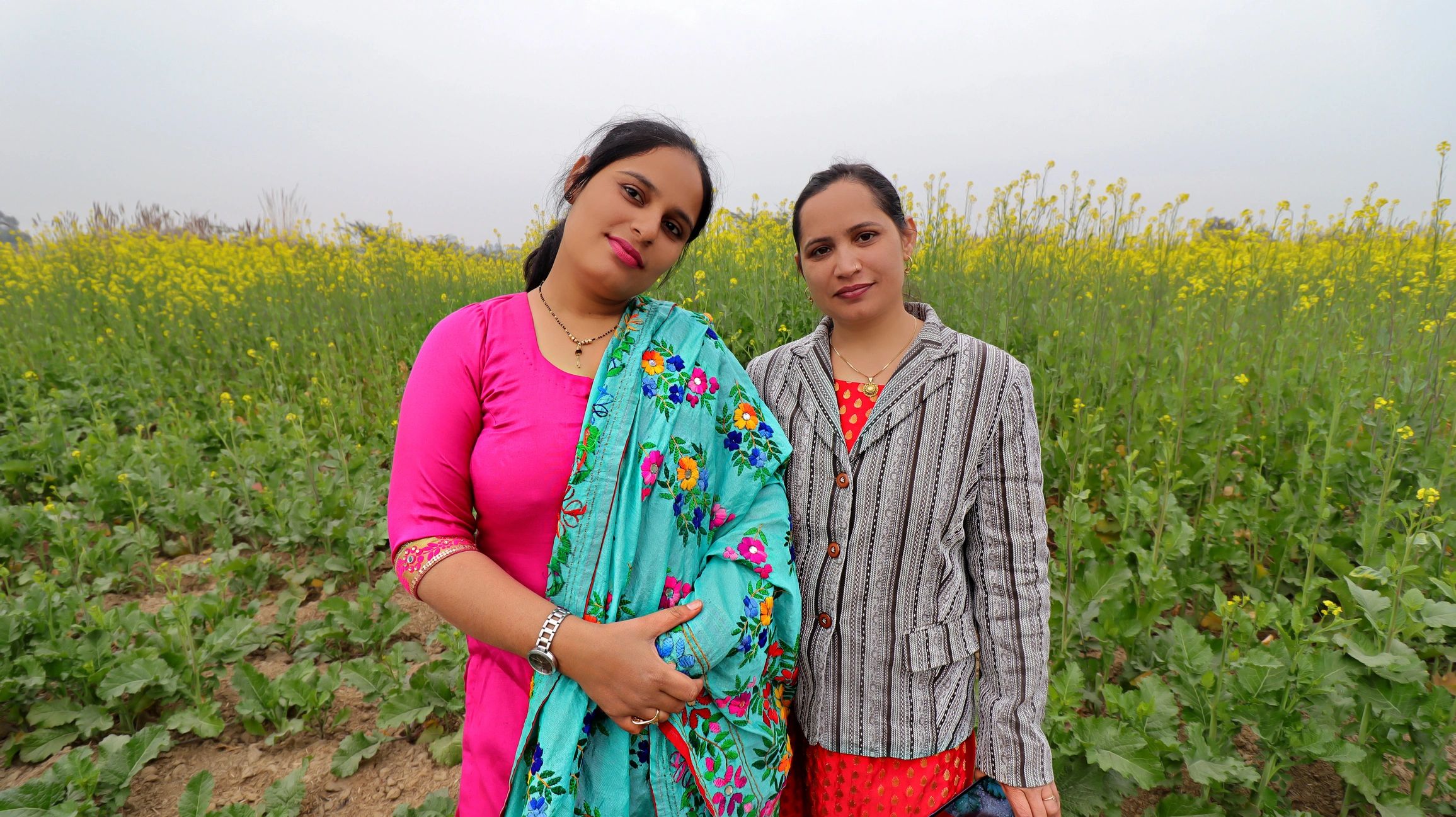 Women standing together near a field in rural India