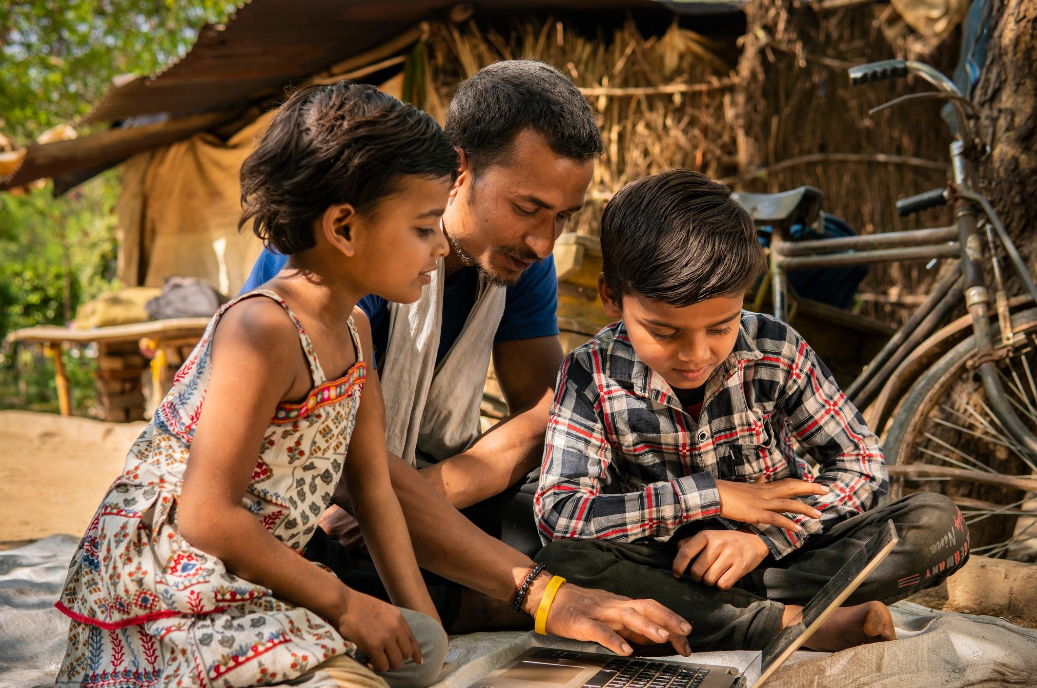 Livelihoods and digital inclusion: rural family using a laptop at home